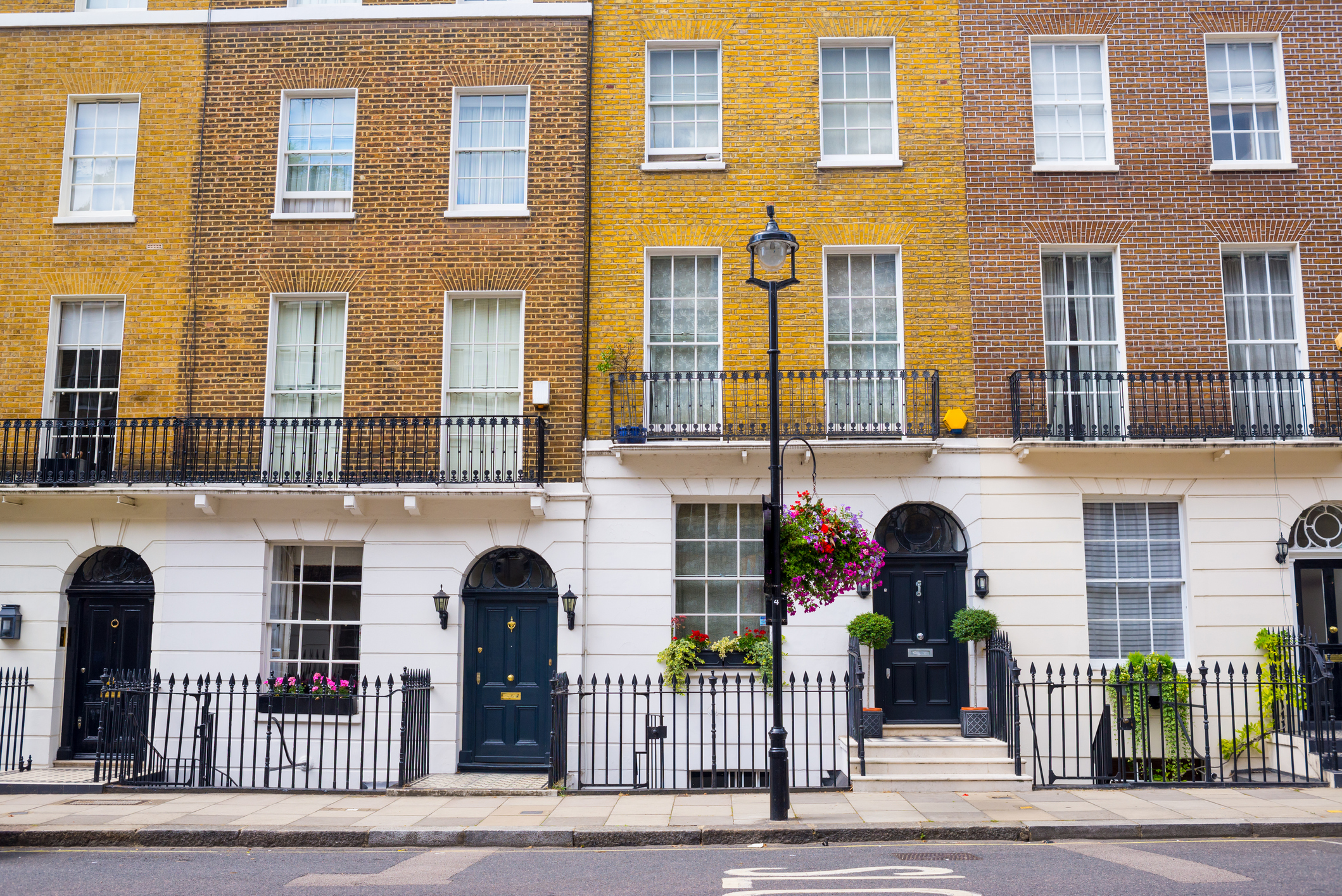 acade of Georgian residential town houses made in yellow and red brick in a luxury residential area of West London.