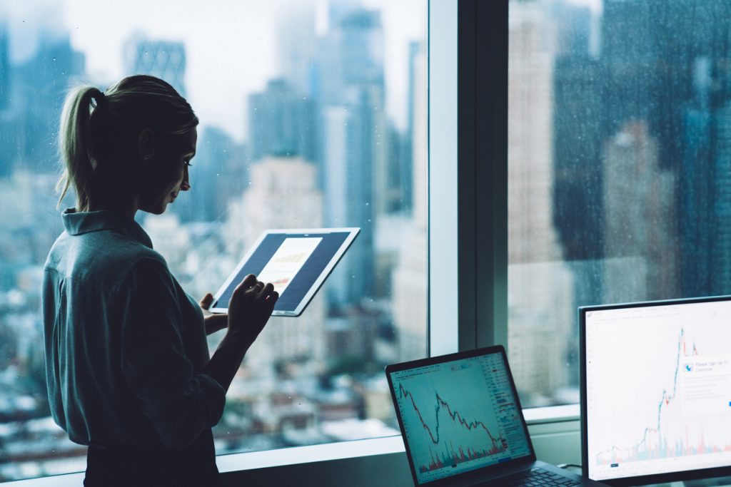 A forensic economist working with a tablet