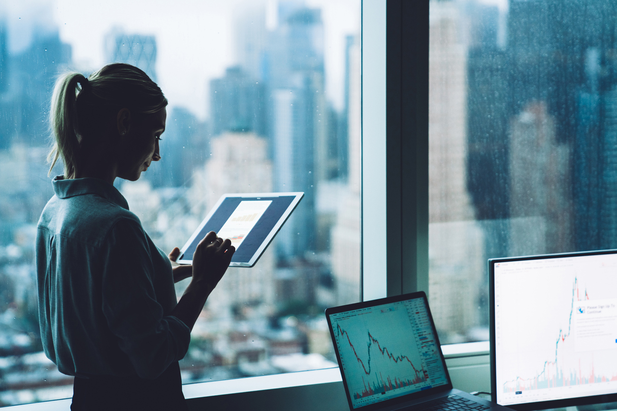 A forensic economist working with a tablet