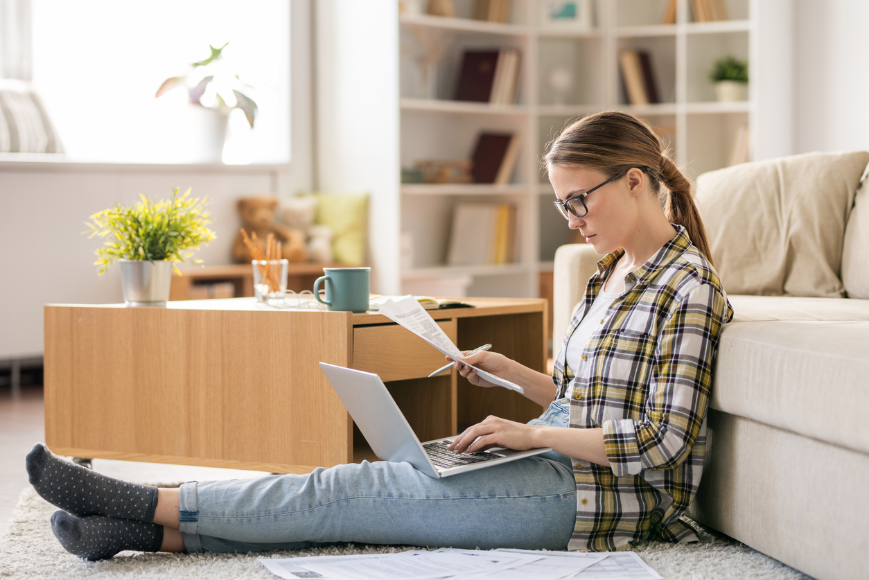 A young woman checking bills at home