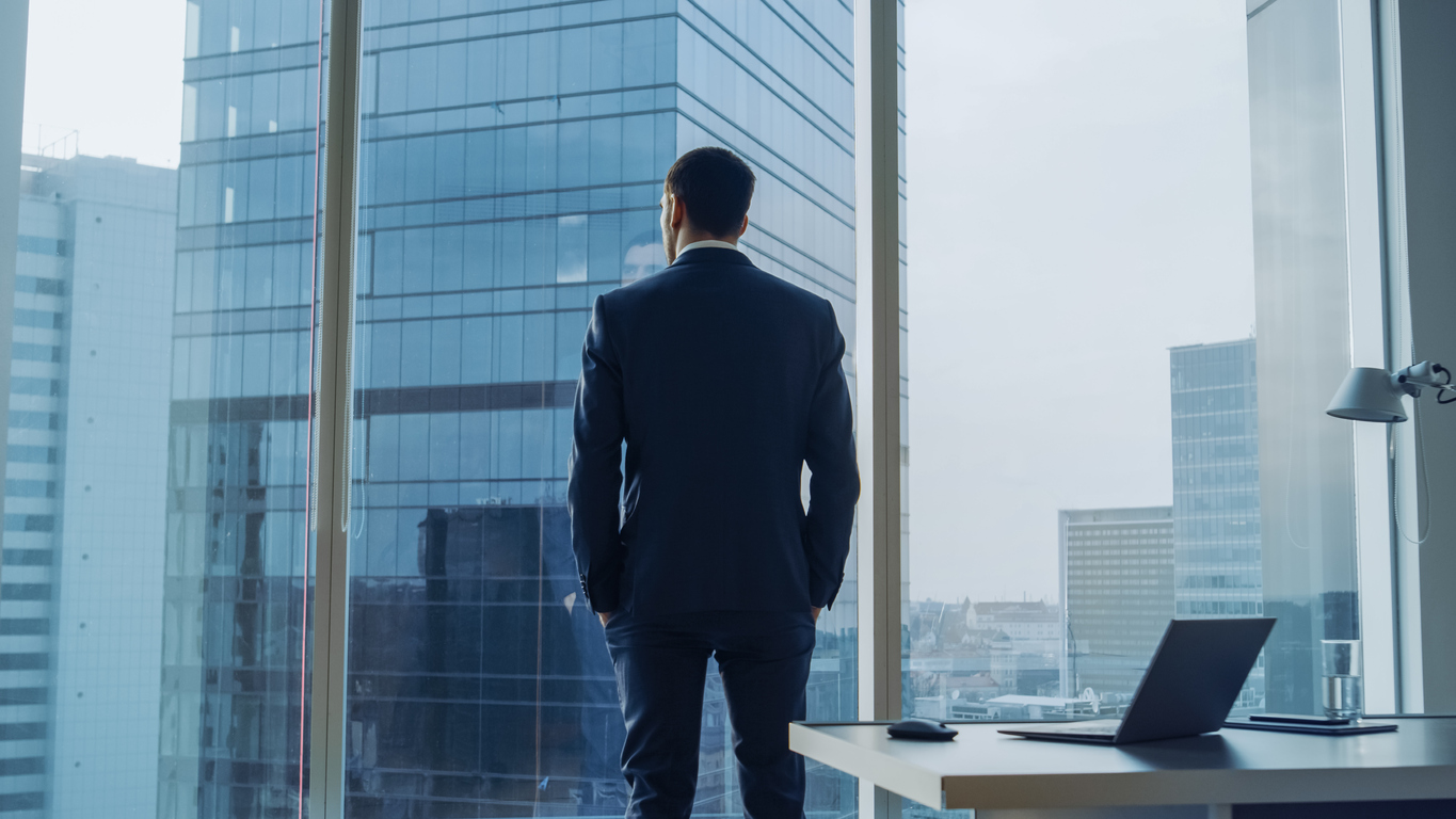 Bank CEO standing at window