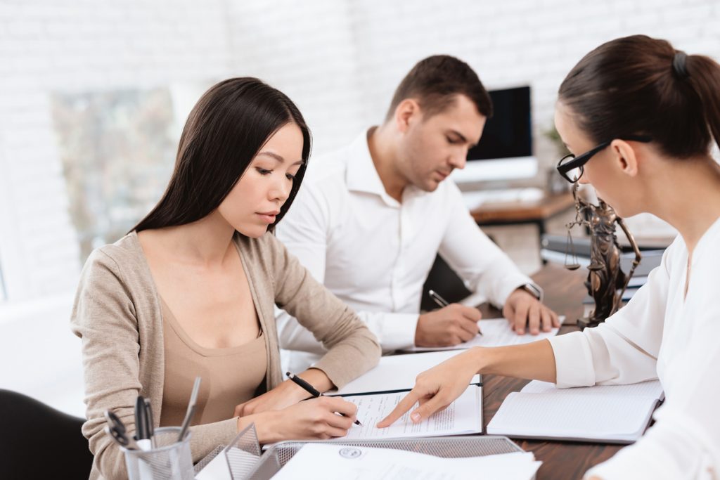 A young couple meeting with a divorce attorney
