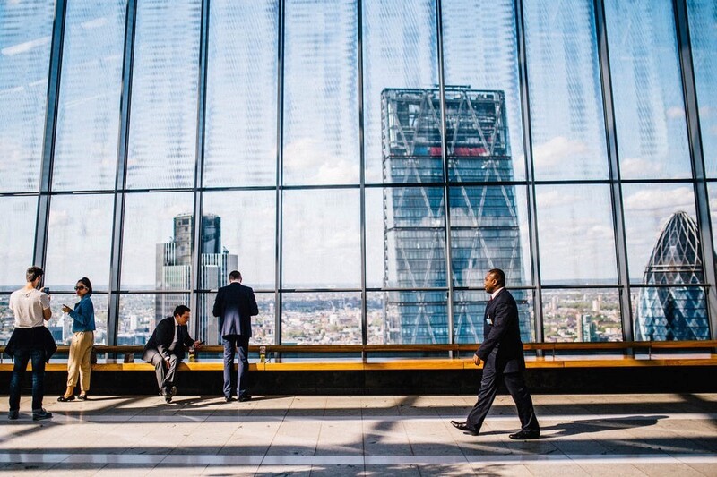 Hedge fund managers next to skyscraper windows