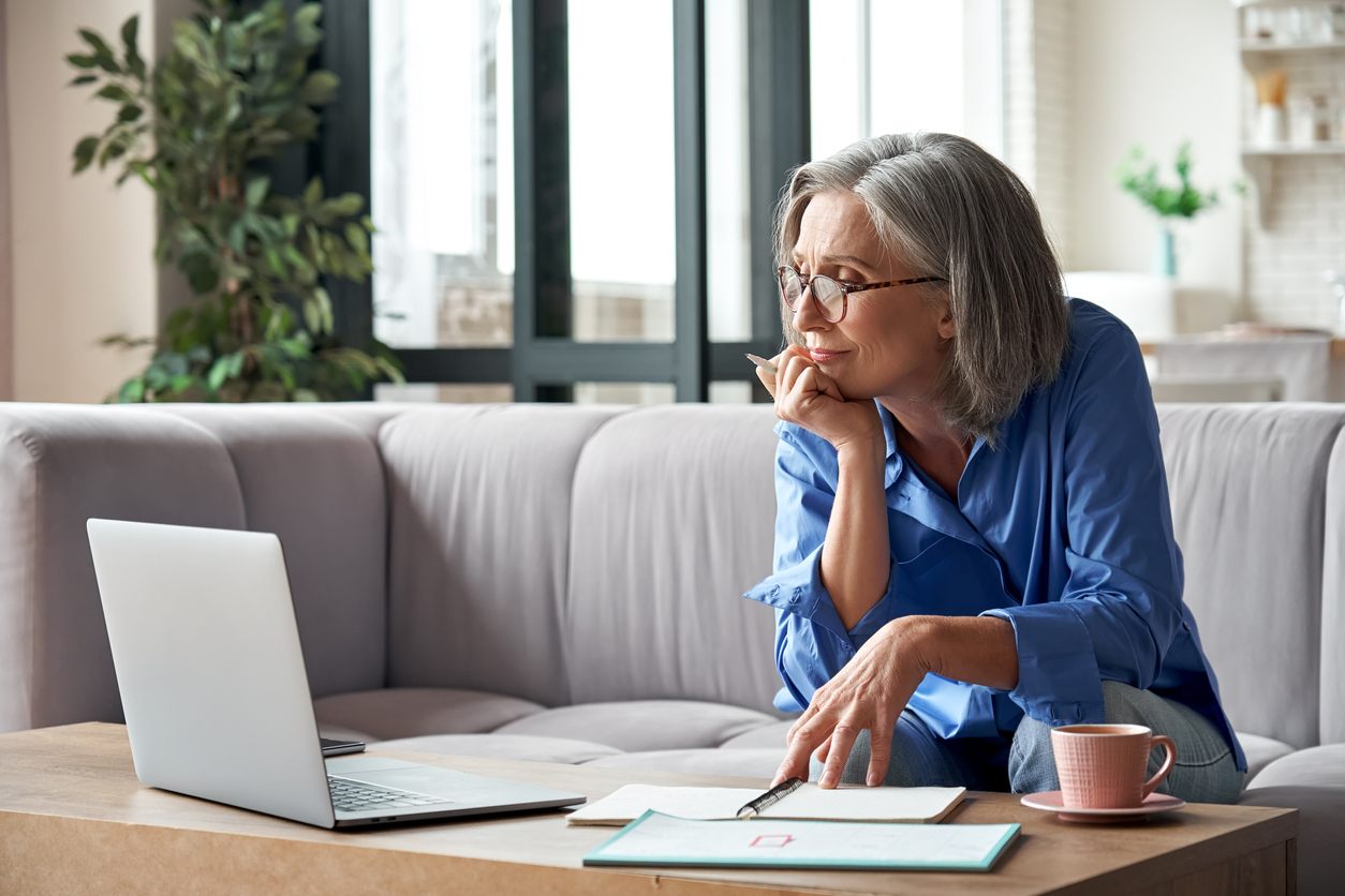 Retired woman watching an online webinar