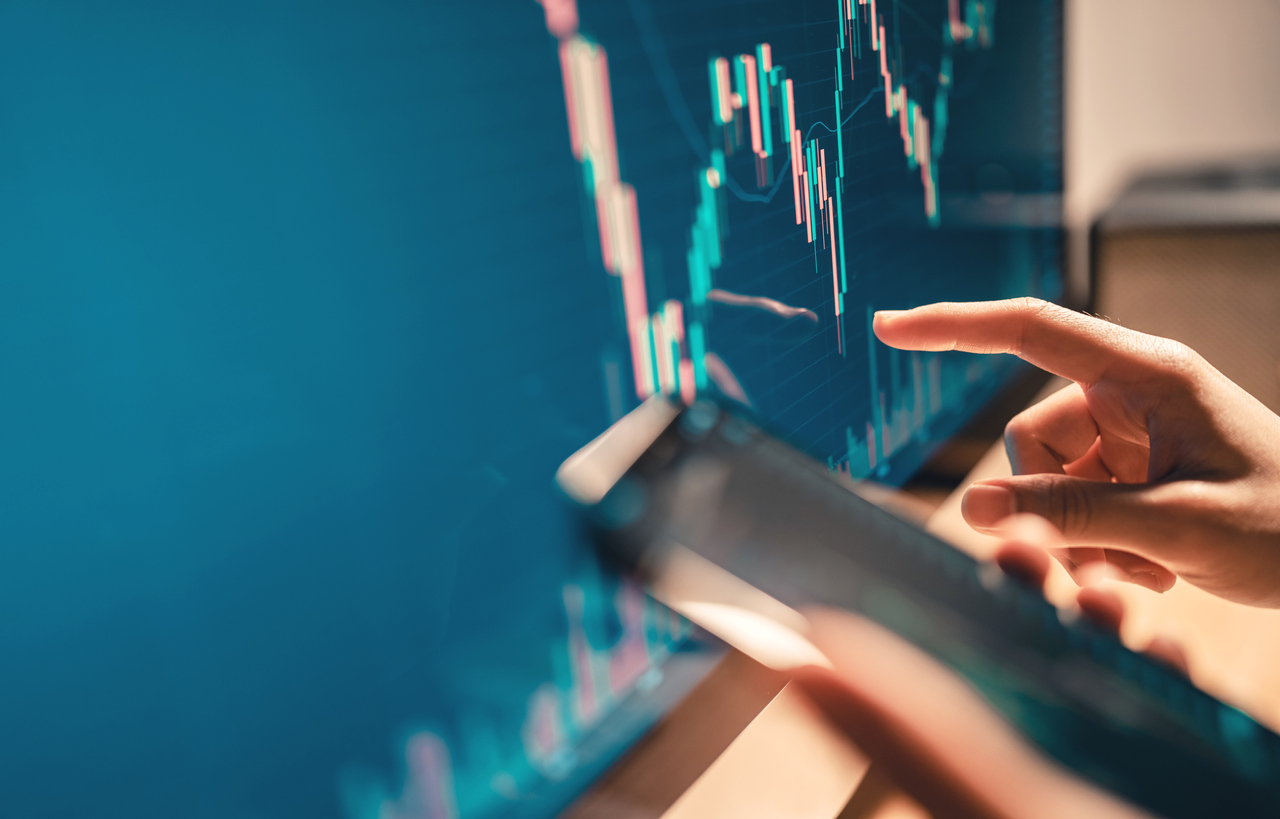 Hand checking bitcoin price chart