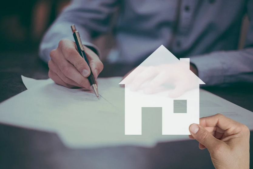 Man signing mortgage paperwork