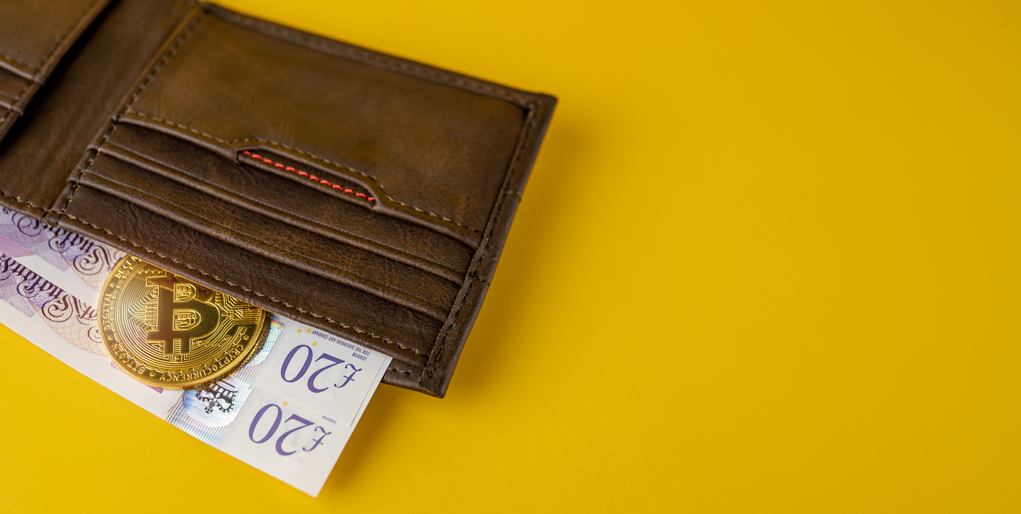 Bitcoin with British pounds in leather wallets