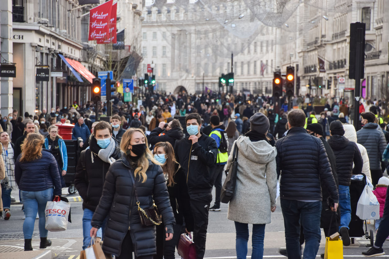People with face masks on Regent Street, London, UK.