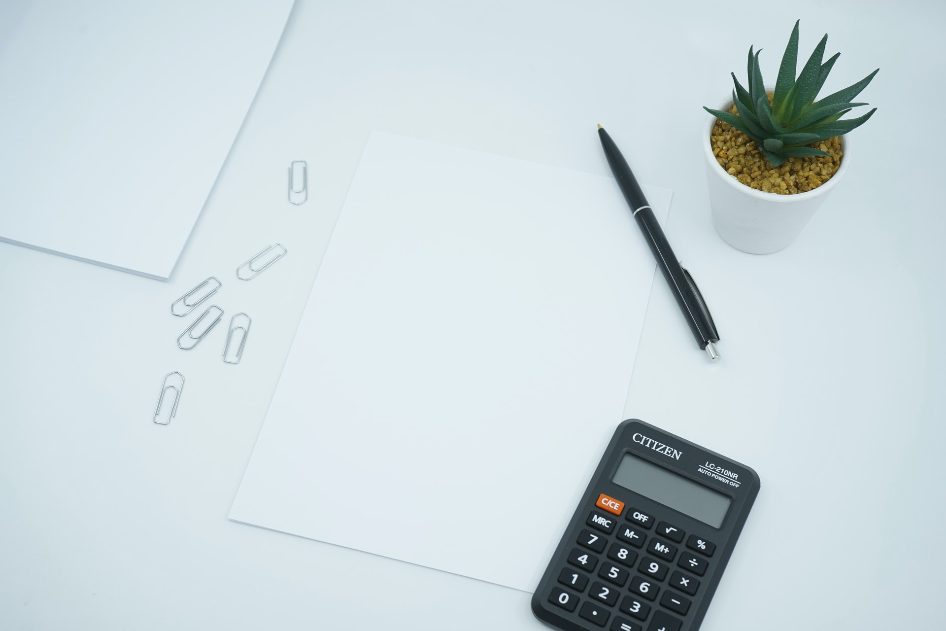 Paper, pen, and calculator for planning start-up budget