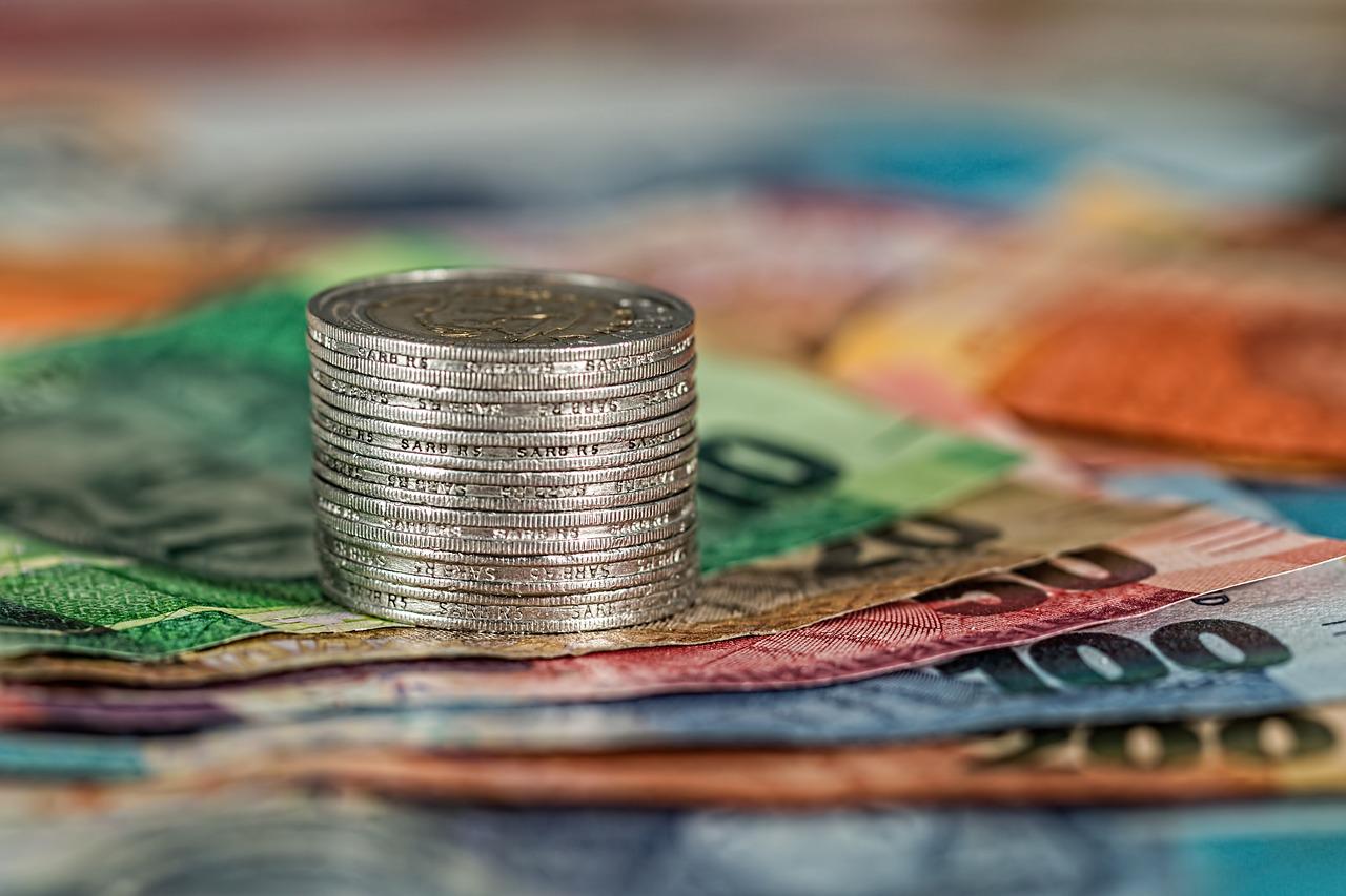 Stack of coins on bank notes