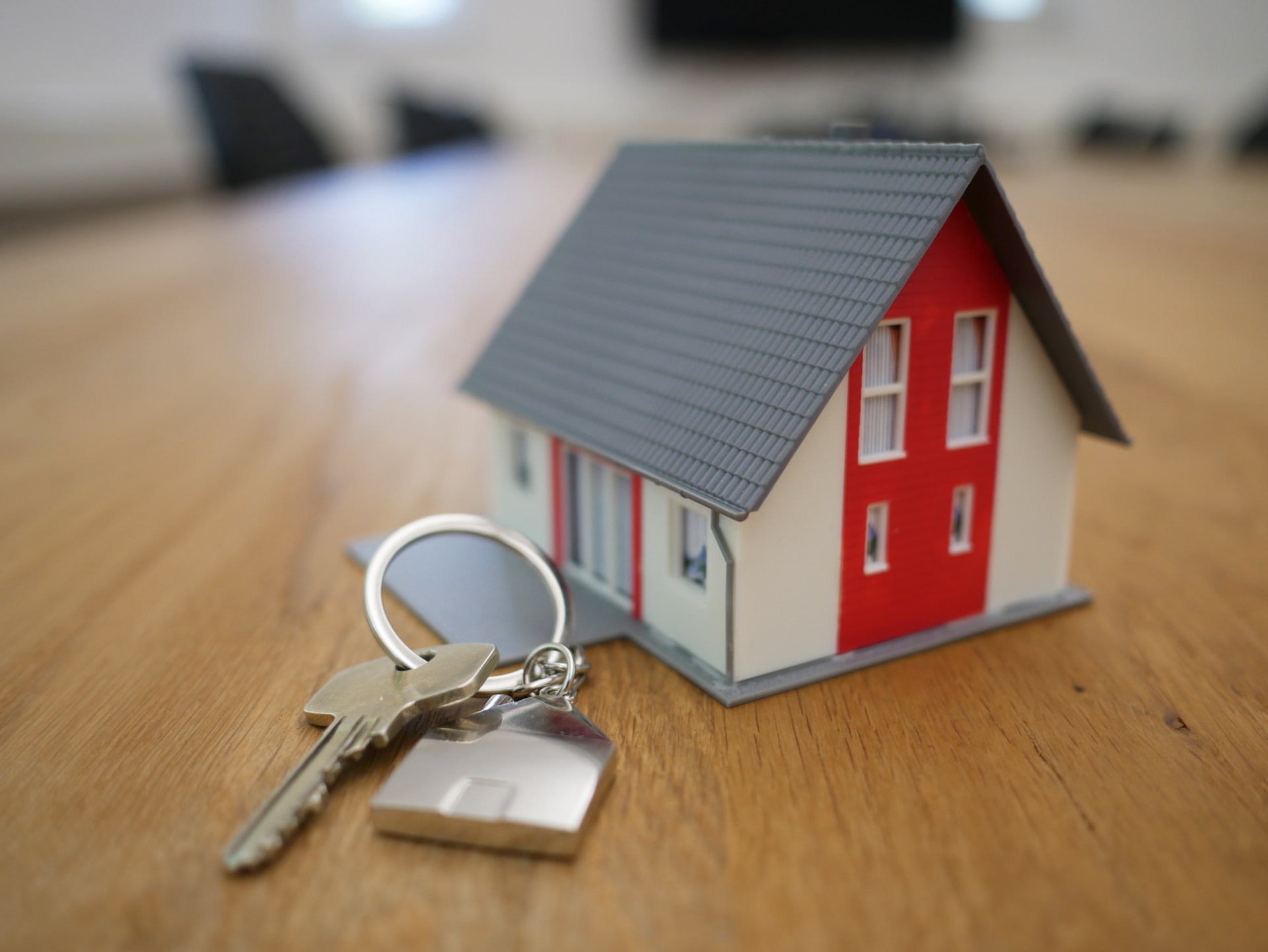 Small house next to keys on table