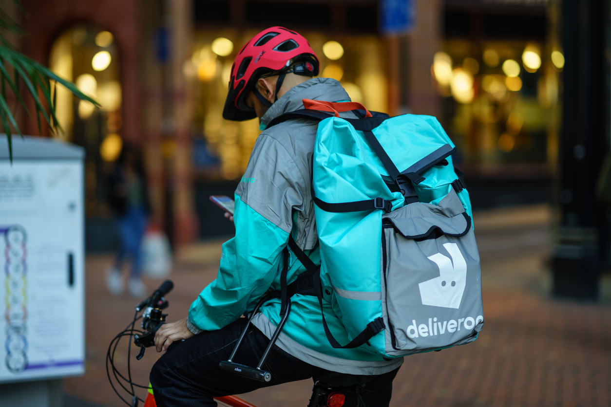 Deliveroo courier checking phone