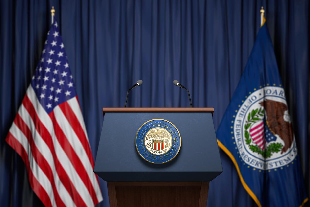 Federal Reserve System Fed of USA chairman press conference concept. Tribune with symbol and flag of FRS and United States.