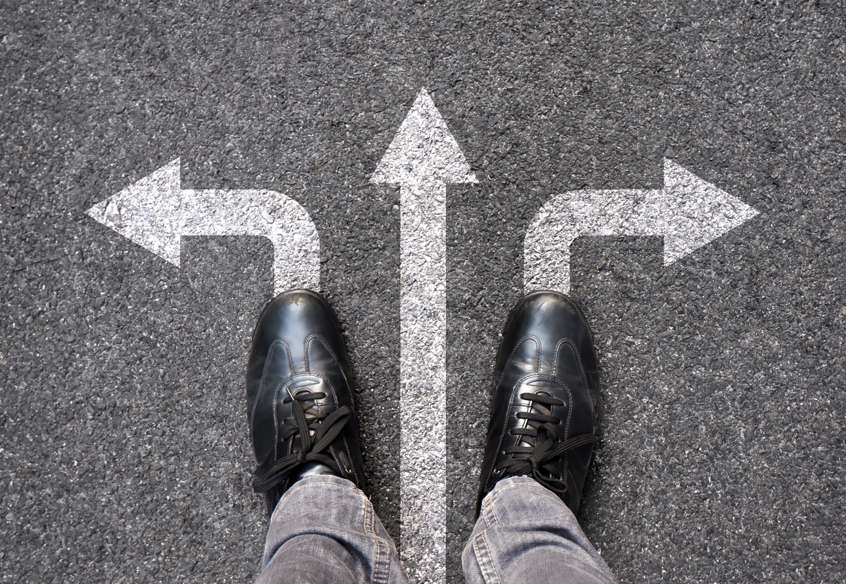 Feet and arrows on road background. Selfie feet above. Businessman standing on pathway with three direction arrows choice or move forward. Top view of business shoes walking. Motivation and growth.