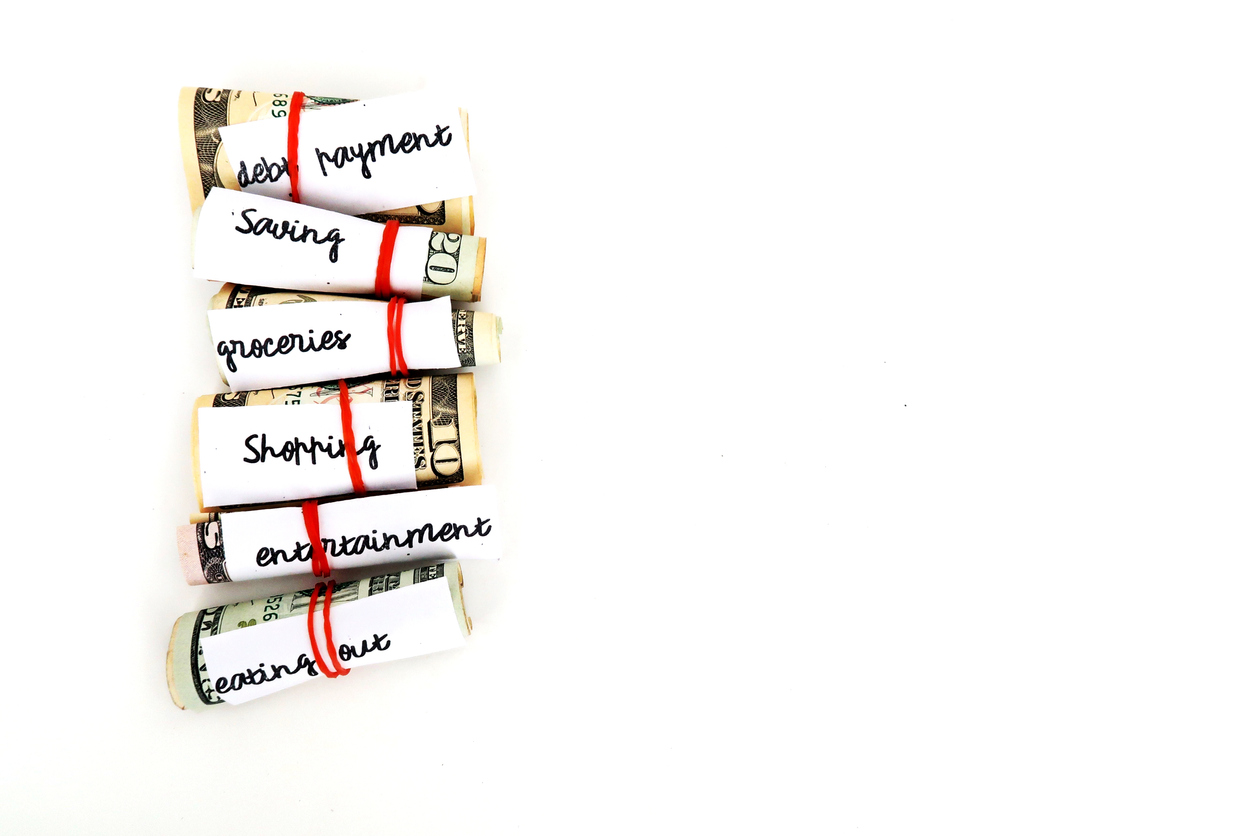 Money management saving budget plan -envelope method, small cash wrapped separately with rubber band limit for variety purposes spending- all on white copy space background