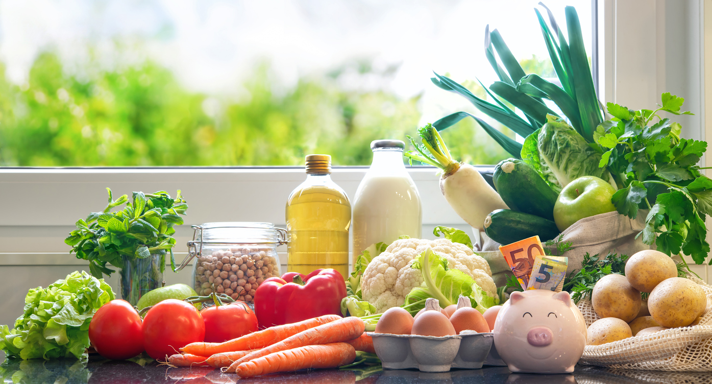 groceries purchases from local market and money in piggy bank
