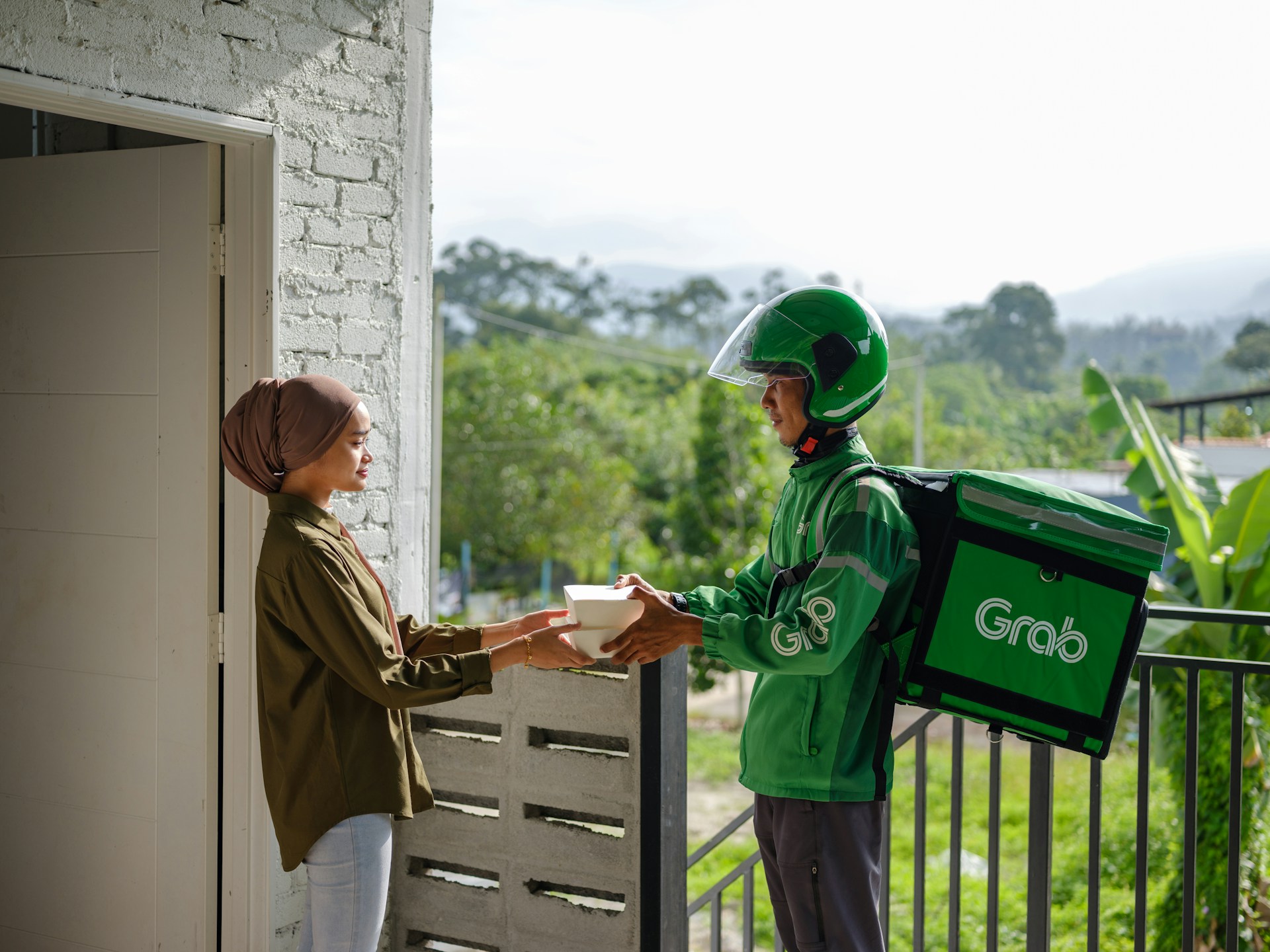 Grab delivery driver, delivering food to a client.