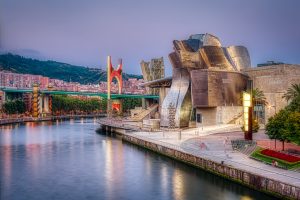 sunset view of modern and contemporary art guggenheim museum and la salve bridge