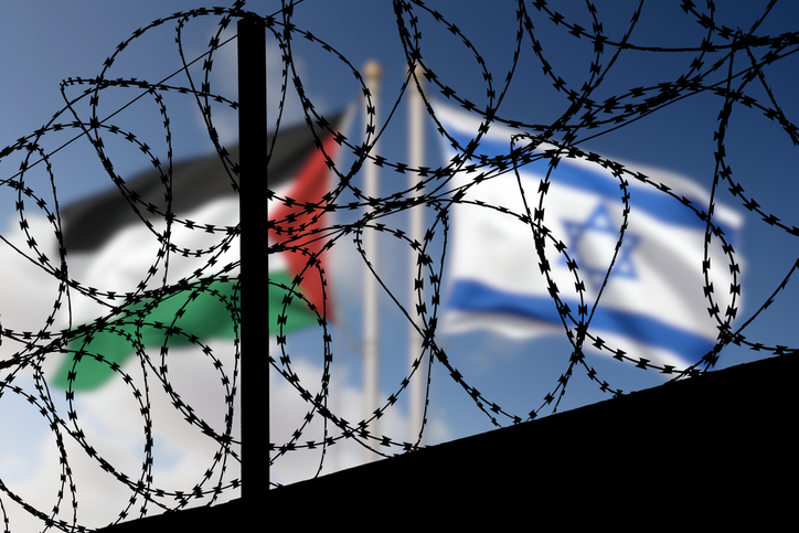 flags of israel and palestine behind the barbed wire