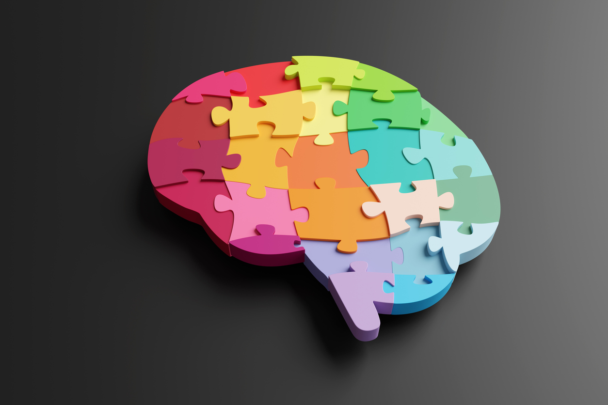 multi coloured jigsaw puzzles forming the shape of a brain on black background. illustration of the concept of intelligence, wisdom, ideas and creativity