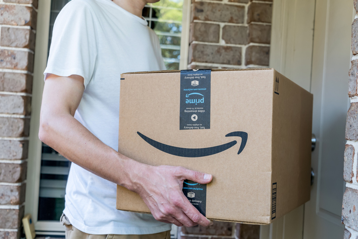 amazon prime big huge box delivered to a front door of residential building.