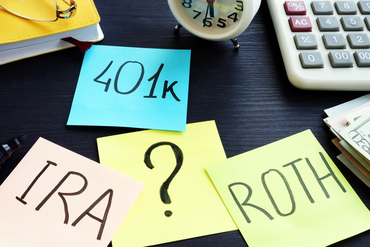 401k ira roth on pieces of paper. retirement planning.