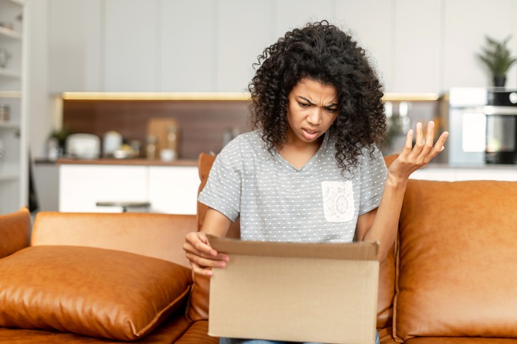 an african american woman unpacking a box