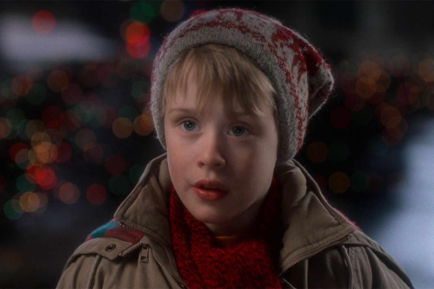 Macaulay Culkin as Kevin McCallister in Home Alone, wearing a woolly hat in a memorable winter scene.