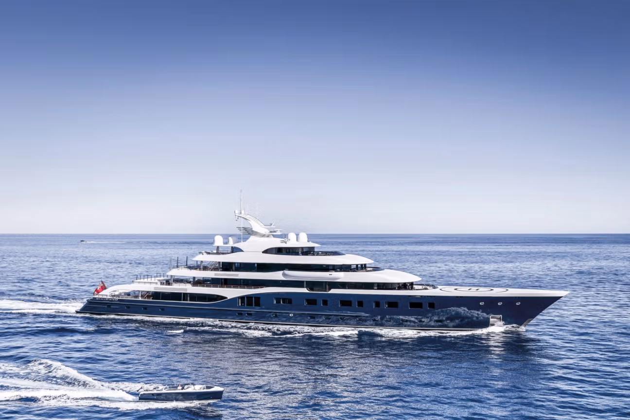 Bernard Arnault’s luxury superyacht Symphony docked at sea, showcasing its sleek design and multi-deck structure.