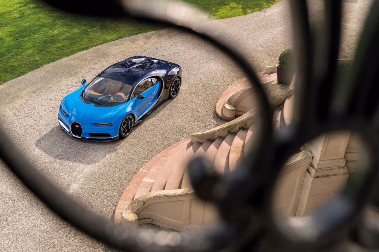 Bernard Arnault’s blue Bugatti Chiron parked outdoors, showcasing the hypercar’s distinctive design and performance styling.