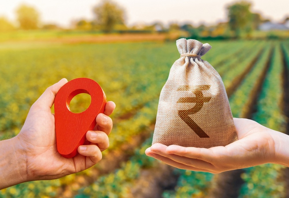 hands,with,location,pin,and,indian,rupee,money,bag.,land