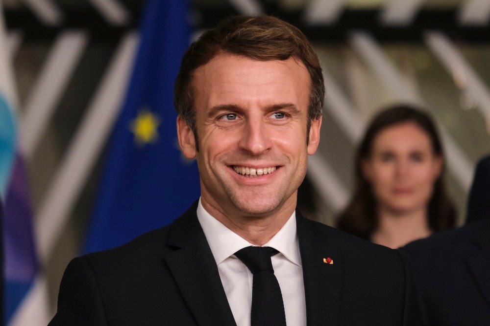 french,president,emmanuel,macron,reacts,as,he,poses,with,members