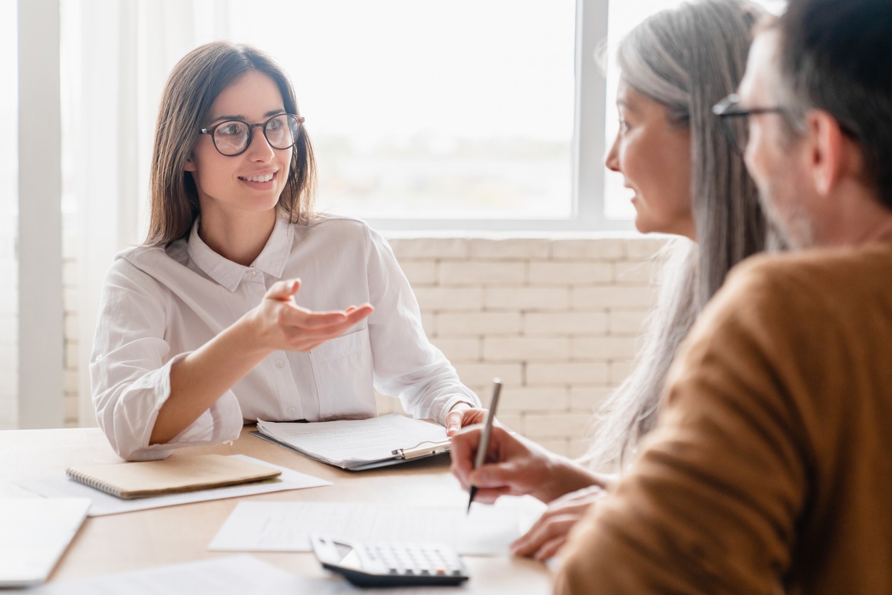 insurance agent lawyer financial advisor broker discussing consulting mature middle aged couple signing contract documents, buying property, investments at home