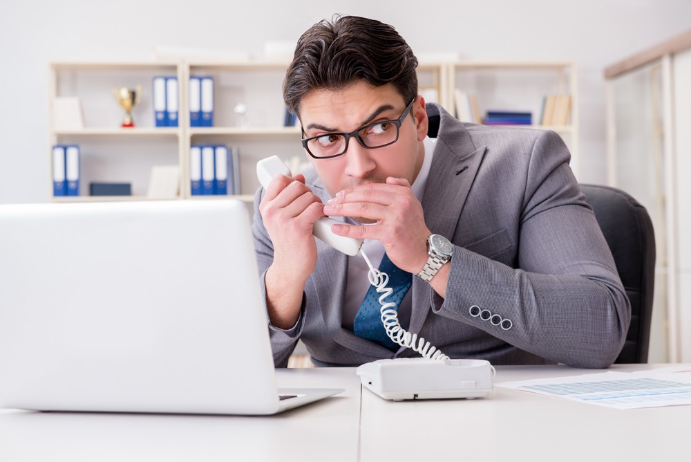 businessman,leaking,confidential,information,over,phone