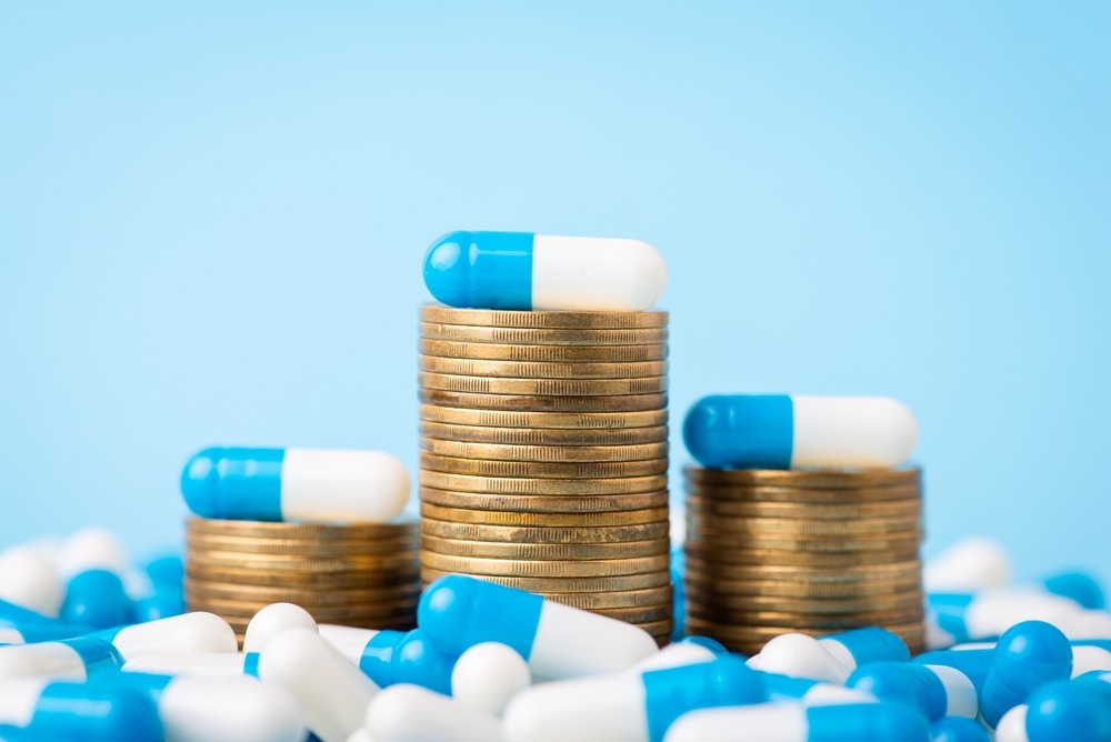 stacks,of,coins,between,medical,pills,capsules.,concept,of,expensive