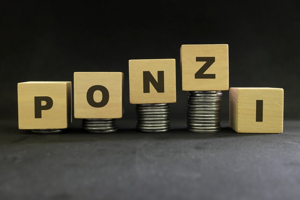 ponzi,scheme,concept.,stack,of,coins,on,wooden,blocks,with