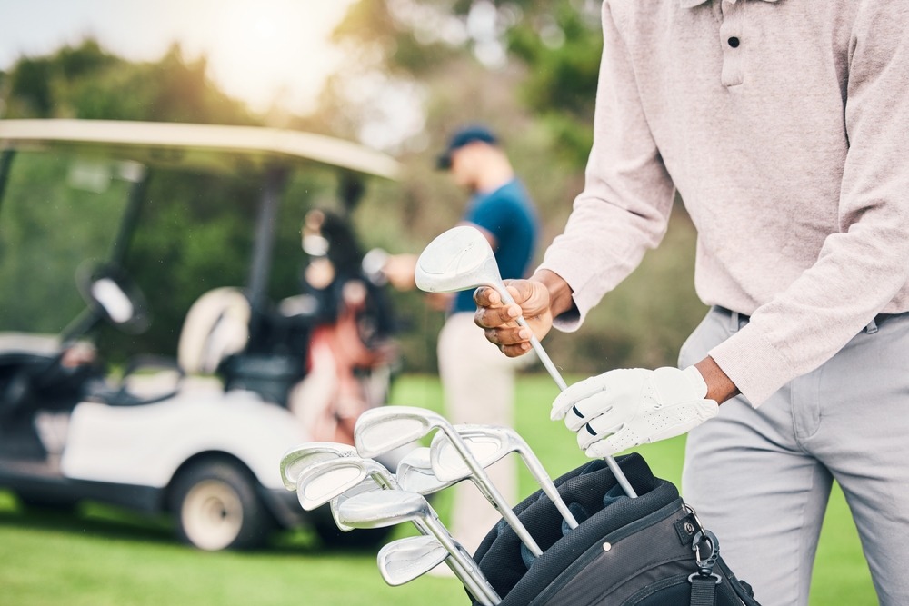 golf,,choose,club,and,hands,of,man,with,golfing,bag