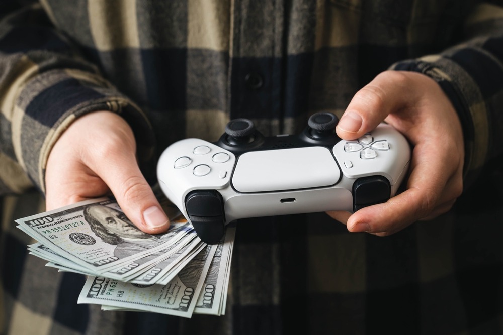 a,man,plays,a,video,game,,a,white,gamepad,and
