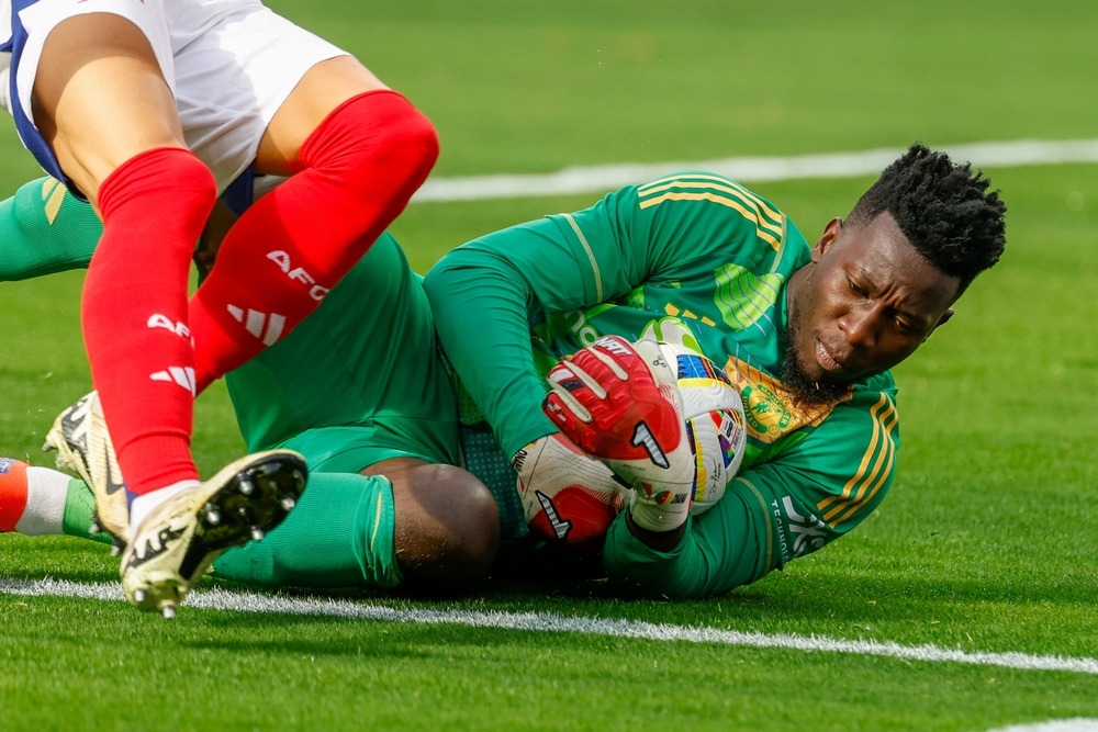 manchester,united,goalkeeper,andre,onana,#24,makes,save,during,a