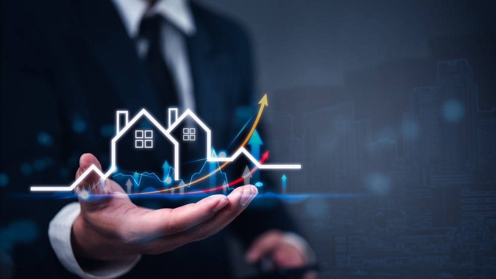 businessman,holding,virtual,graph,showing,real,estate,market,growth.,perfect