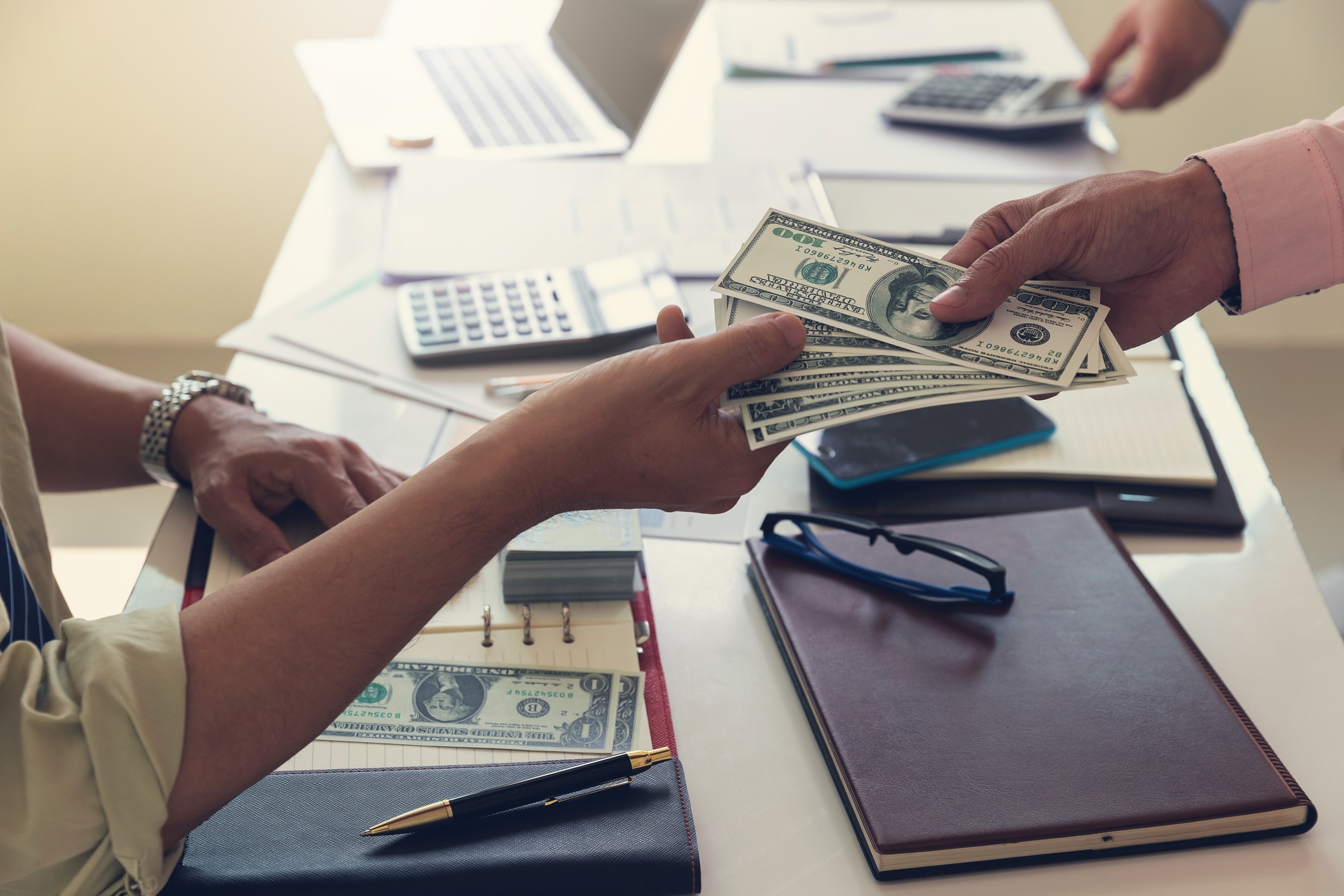 business and finance concept of office working, businessman giving money to his partner for profit of investment.