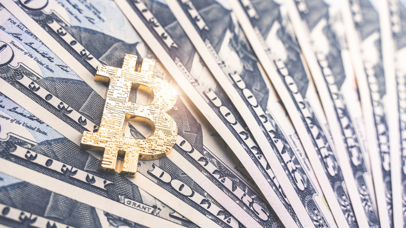 physical version of bitcoin and dollar banknotes. exchange bitcoin for a dollar symbol. conceptual image for worldwide cryptocurrency and digital payment system