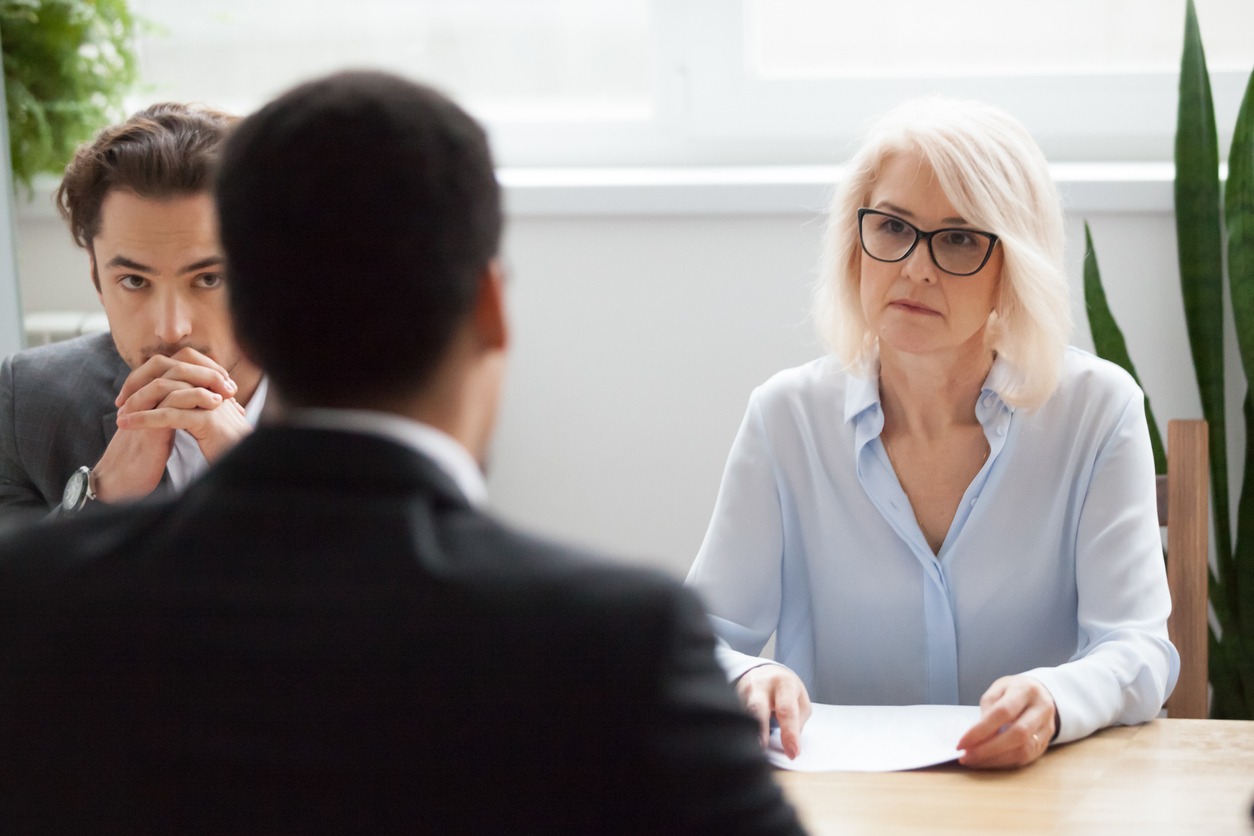 serious attentive senior hr listening to candidate at job interview