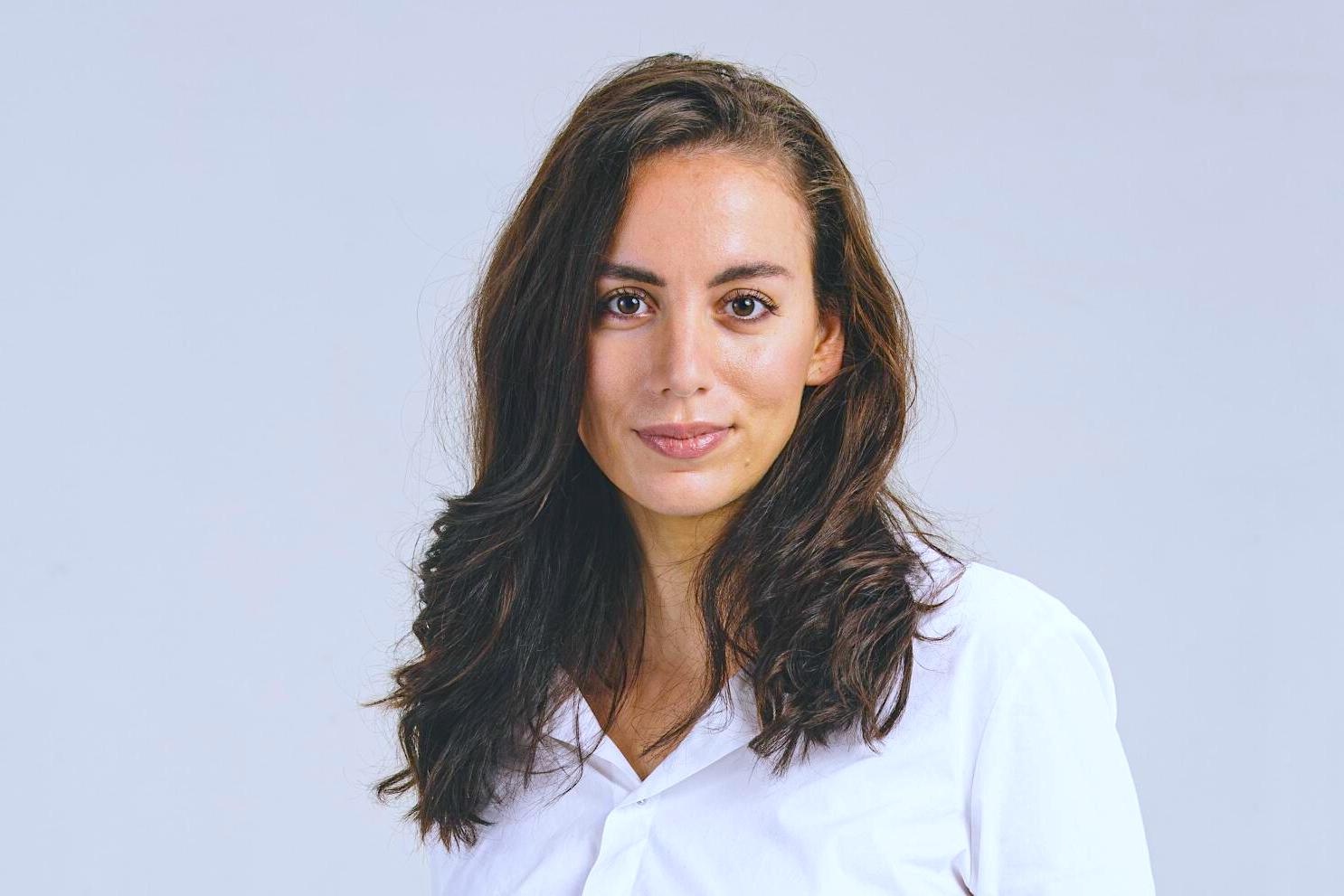 Mira Murati professional headshot wearing a white shirt, looking confident and poised.