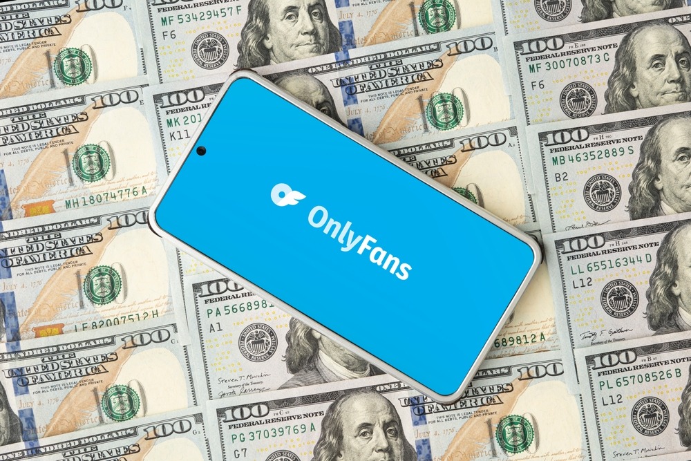 onlyfans,logo,on,smartphone,screen,and,dollar,bills.,onlyfans,is