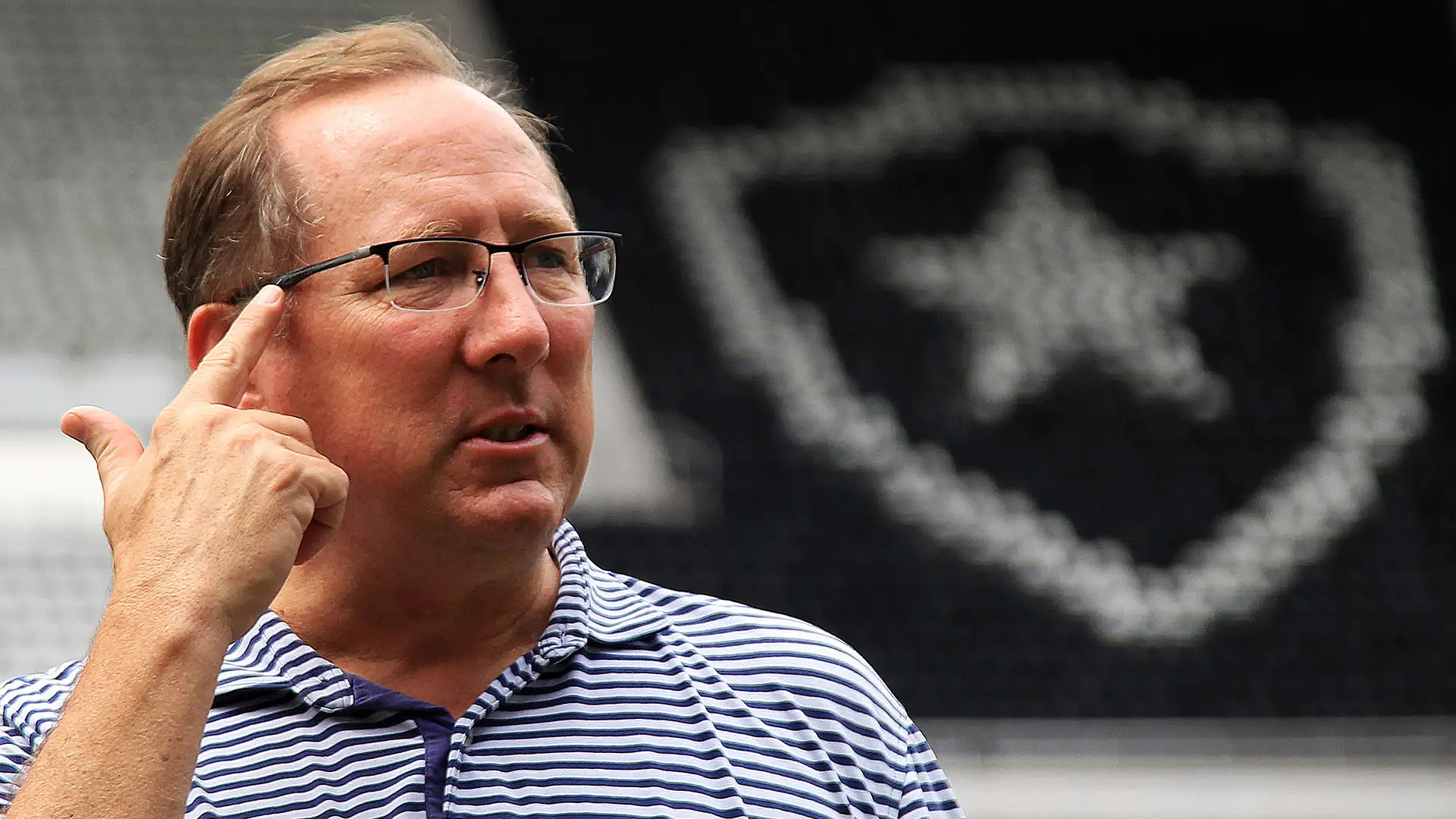 John Textor standing inside Botafogo’s stadium, surrounded by empty stands, showcasing his presence at the Brazilian club’s home ground.