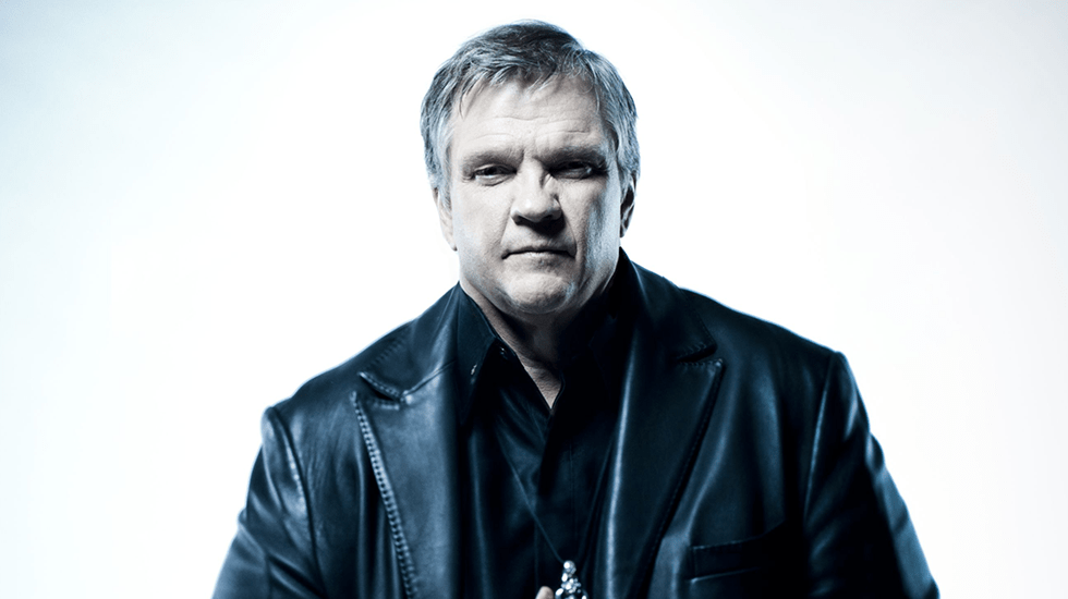 An older Meat Loaf wearing a black leather jacket, posing confidently during a professional photo shoot.