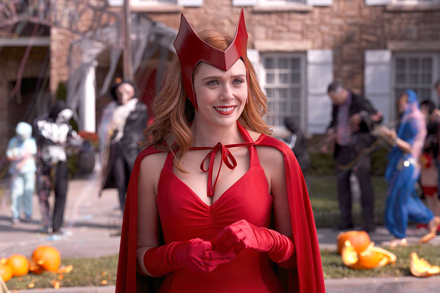 Elizabeth Olsen as Wanda Maximoff in WandaVision, wearing her iconic Scarlet Witch costume with intense focus and power.