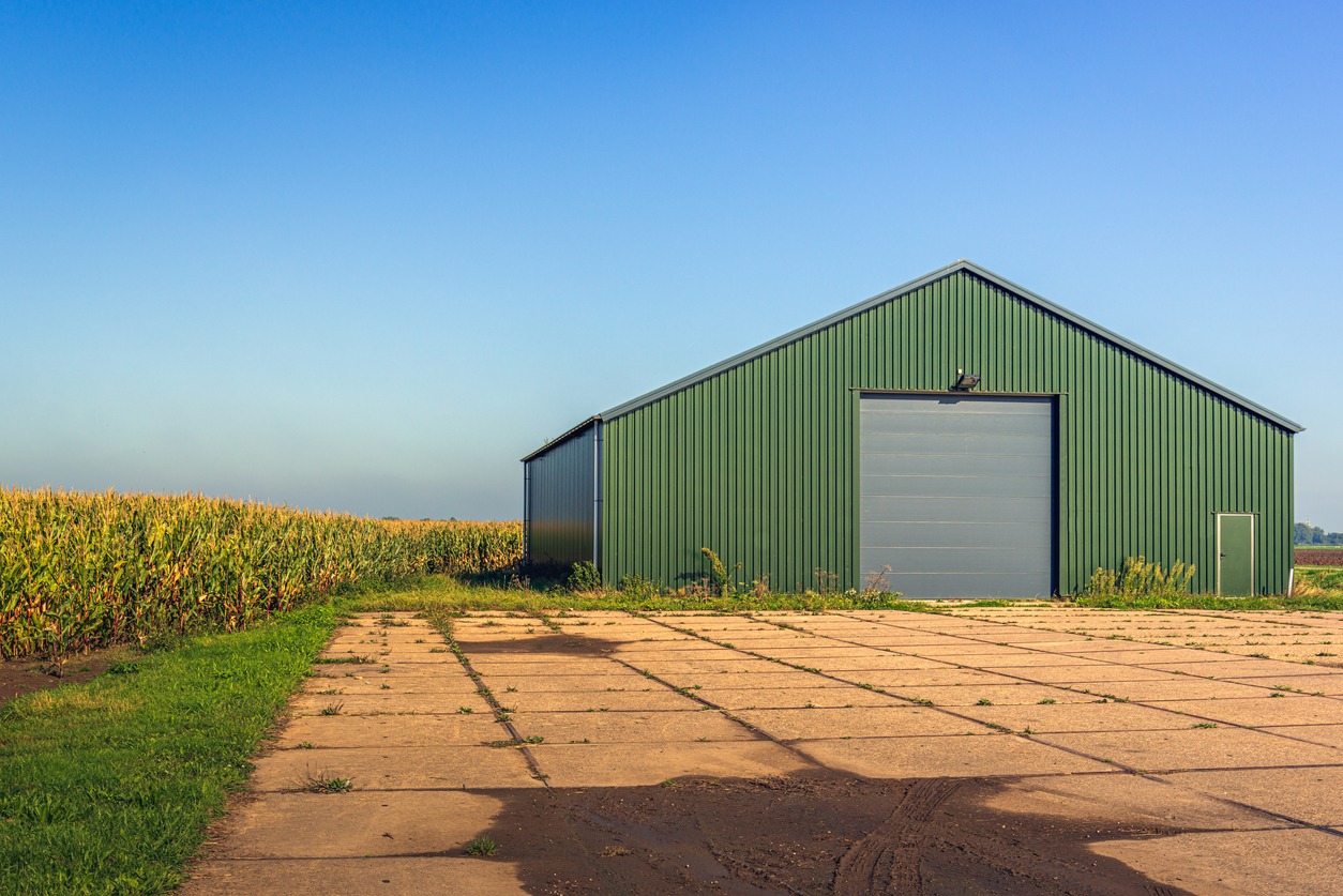 modern agricultural barn with a yard of concrete slabs