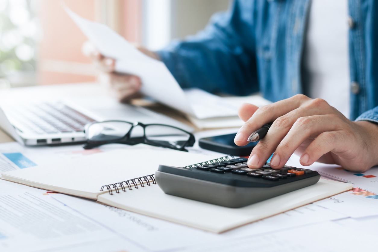 investors are calculating profits and costs with calculators, growth and investment chart analysis, business planning and strategies to maximize sales profits. long term business plan.